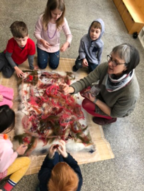 Collaborative wet felted rug project taught to 2nd graders