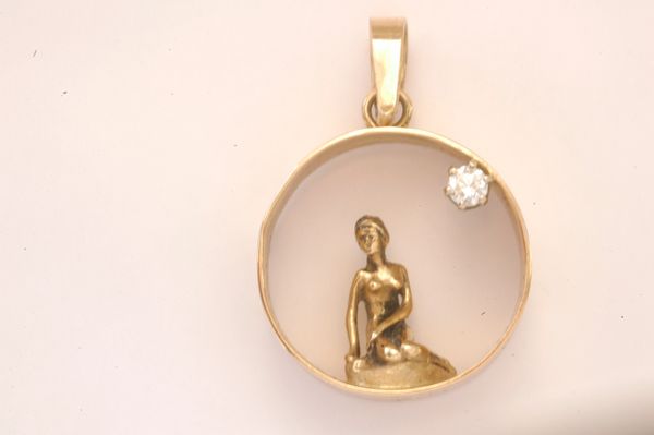 Mermaid Collection. Featured is our beautiful 14K Gold Mermaid inside Ring Pendant with added .10K Diamond.