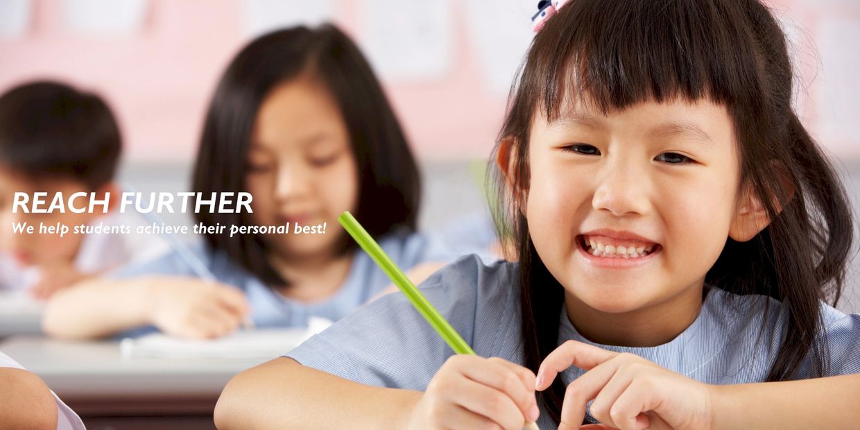 Smiling girl writing in a classroom with encouraging text.