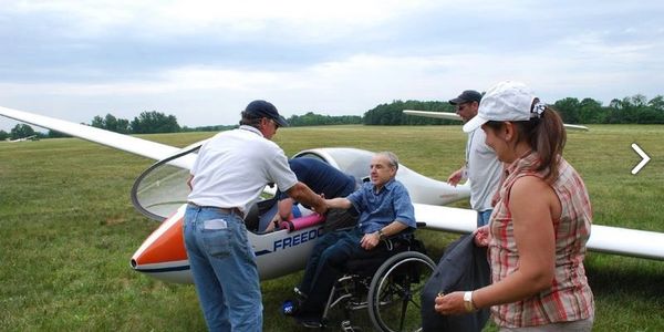 First introduction to a person in their wheelchair in front of the glider before boarding.