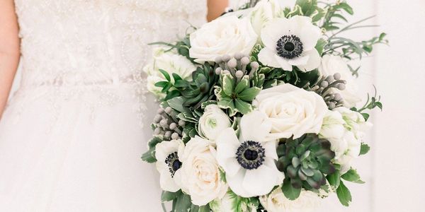 White Wedding Flower Bouquet in the hands of the bride.