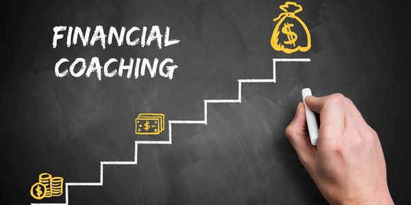 Hand drawing on a blackboard with chalk stating financial coaching with a stepping ladder.