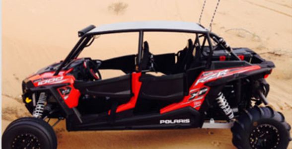 Off-road Polaris vehicle in a desert.