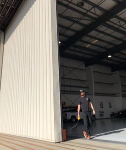 a man walks through an open door in a warehouse