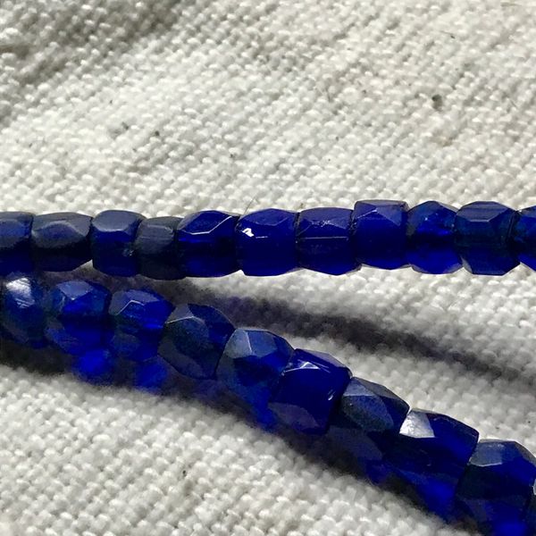 SOLD 1800s AFRICAN GRADUATED DARKEST COBALT BLUE RUSSIAN BLUE FACETED GLASS TRADE BEADS ATELIER RESTRUNG ON AMERICAN HANDCUT DEERSKIN LEATHER 24” LONG
