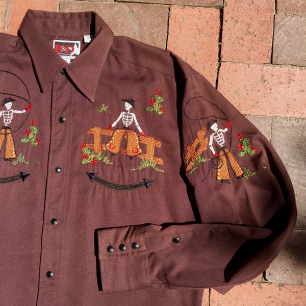 SOLD 1970s BROWN POLYESTER EMBROIDERED RODEO COWBOY SKELETONS WESTERN BLACK SNAP SHIRT