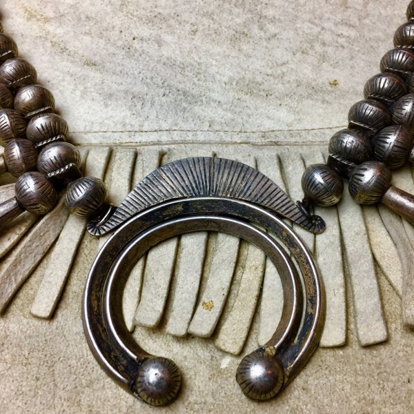 SOLD 1920s RARE INGOT SILVER 20 BLOSSOM CHISELED BENCH BEAD & NAJA SQUASH BLOSSOM NECKLACE ATELIER RESTRUNG ON AMERICAN DEERSKIN.