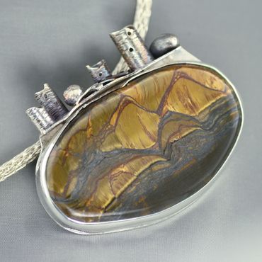 Sterling silver pin/pendant featuring Marra Mamba tiger's eye.  Does not include chain.