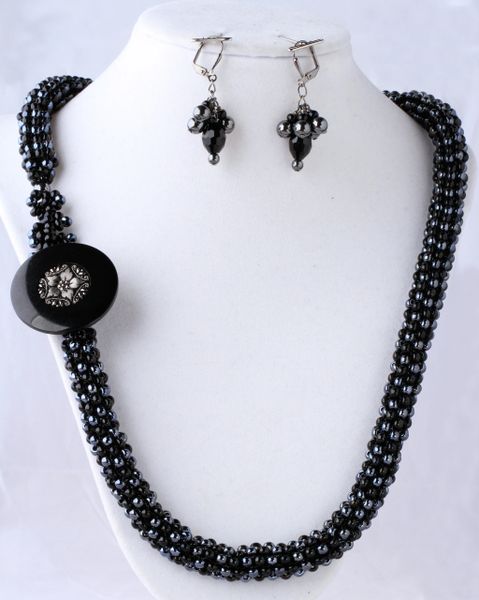 Black and hematite seed beads with antique button. Matching earrings.