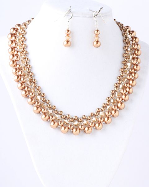 Handwoven gold-colored glass pearls with matching crystals.