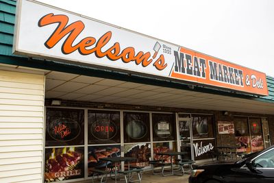 A Nelson Meat Market Board in Orange and White