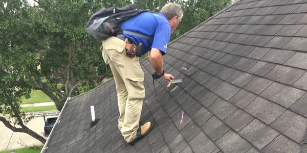 Insurance adjuster inspecting a roof