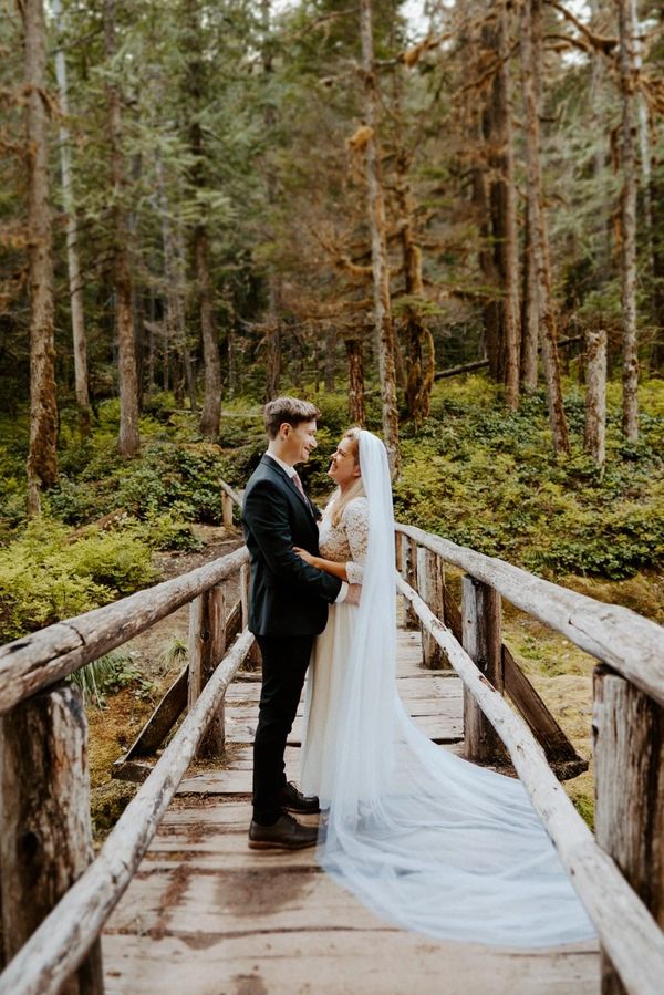 bride & groom on a wooden bridge in the forest.
copyright Sabrina Kaye photography.