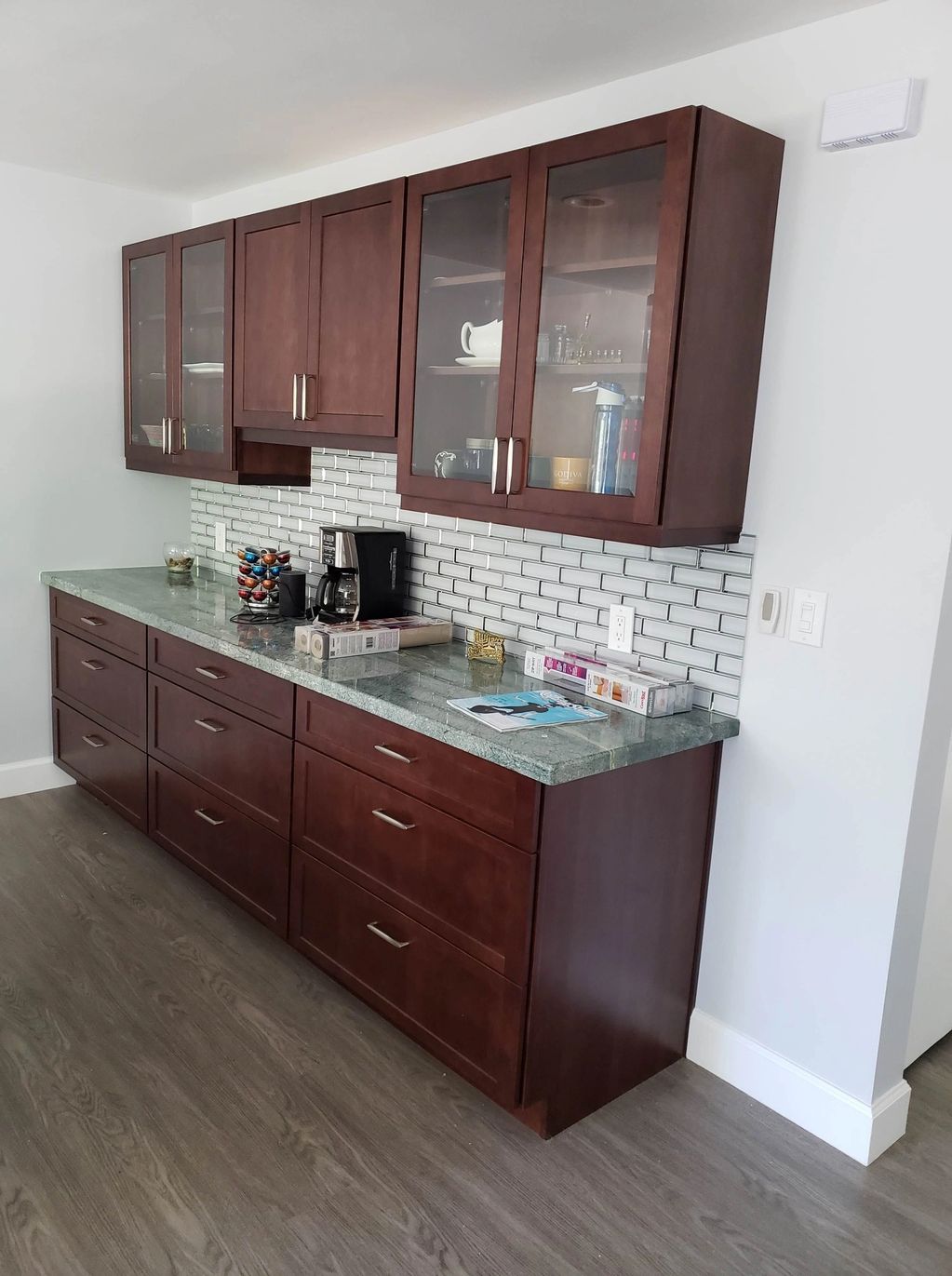 Cabinets feature glass uppers as well as a gorgeous quartzite countertop. 