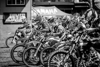 Black and white image of motocross riders lined up.