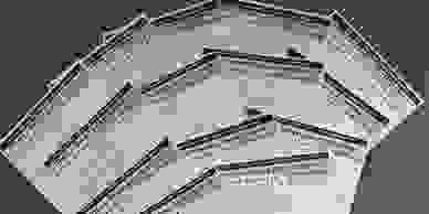 Fourteen questionnaire sheets of paper spread out on a table.