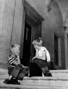 Franky Moline, 8, and Gary D. Norsworthy, 8, sit dejectedly on September 11, 1950 awaiting the openi