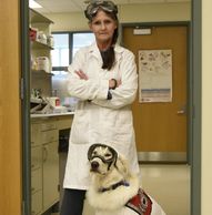 Vice President and Co-Founder Joey Ramp dressed in PPE with Service Dog Sampson dressed in PPE in th