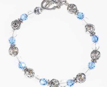 Bracelet has Swarovski light sapphire crystals, silver beads, round clear beads and toggle clasp