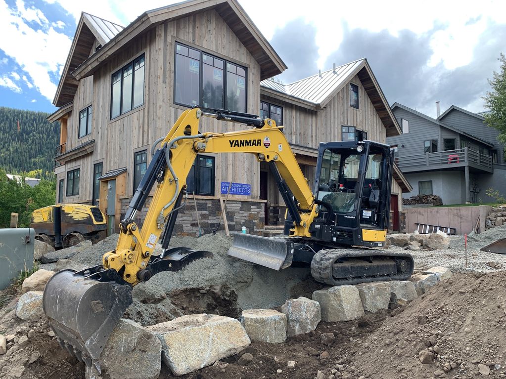 Ol Blue Dirtworks building a rock wall for homeowner.