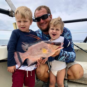 Captain Anthony pictured with his boys in 2019 holding a hogfish. 