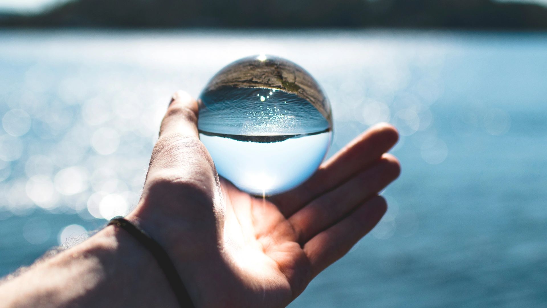 Hand holding globe. Micronic Technologies | Wastewater treatment technology
