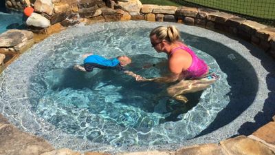 Infant swimming lessons instructor, Kimberly Dehler, with a six month old learning to swim float swi
