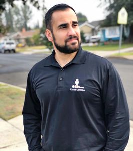 paul is standing outside with his hands in his pocket, wearing a valley cpr guy shirt