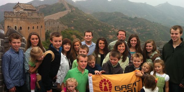 Large family posing at the Great Wall of China.