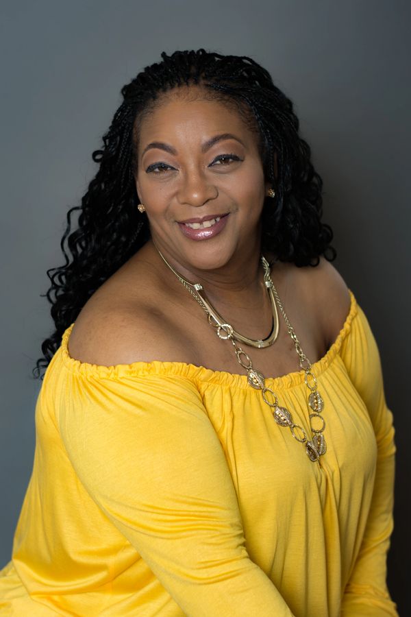 Woman smiling,  yellow shirt, encouragement leader, sister