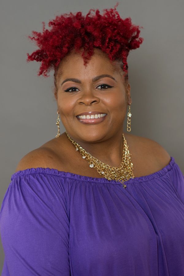 Woman smiling, purple shirt, encouragement leader, sister