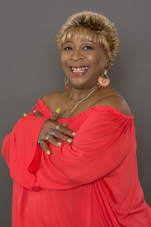 Woman smiling, red shirt, encouragement leader, sister