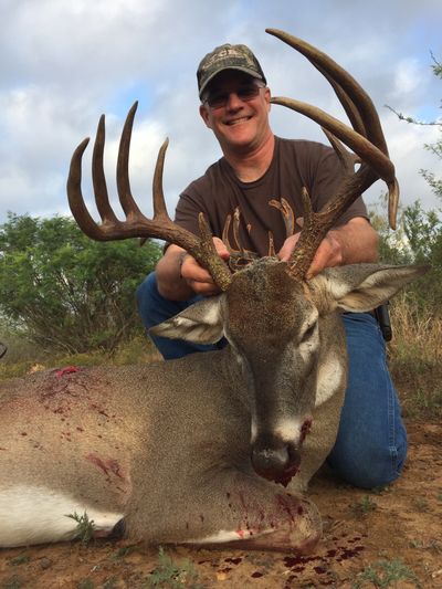 This is an image of a man with a hunted whitetail deer trophy.