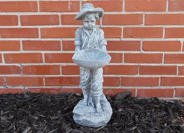 Farm boy cement statue