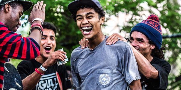 Four guys, sweaty and happy.  One has won a competition and he is beaming with happiness.  His buddi