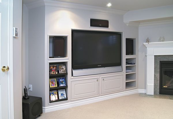 Entertainment Unit made with MDF, has a large screen TV the walls are grey and the unit is grey.