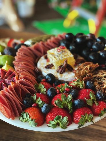 Charcuterie Board with an assortment of meat, cheese, and fruit.