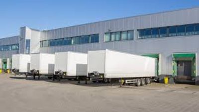 LTL carriers at a warehouse dock to pick up and deliver less-than-truckload freight shipments.