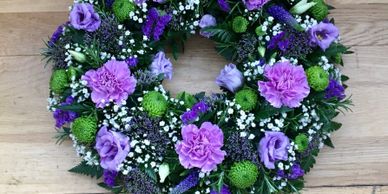 Funeral wreath of blue and lilac flowers