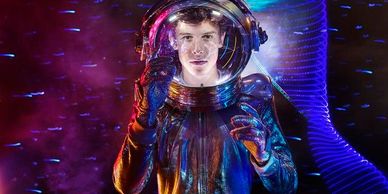 A person in a futuristic astronaut suit with vibrant purple and blue lighting.