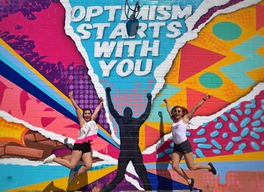 Optimism Starts with You mural by Los Otros Murals. 