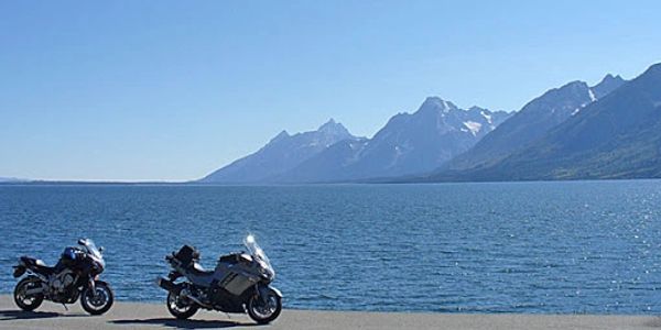 Motorcycles parked overlooking a mountain lake