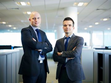 here we ahve 2 businessmen photographed for annual report in their office