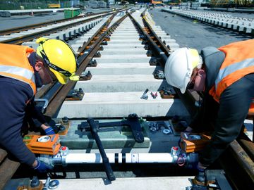 2 men photographed working a a railway lines