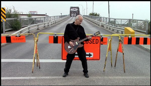 Guitarist Randy Rhythm has the Arlington Overpass closed for Hazardous Noise Rock