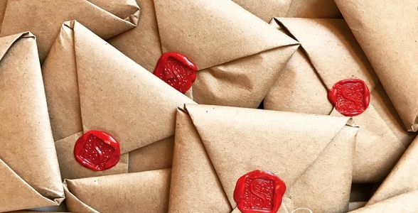 Brown envelopes sealed with red wax stamps.