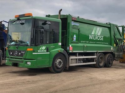 green large dustcart with wilrose logo