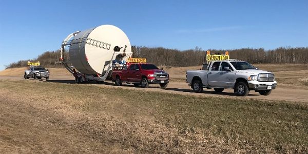 Hopper bottom Grain Bin move with 1 ton and crane style bin mover. 2 pilot trucks. 