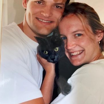 Owners Sara and Dan as a young couple with their first cat, Jack.
