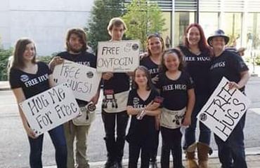 Free hugs group photo art prize Grand rapids Michigan